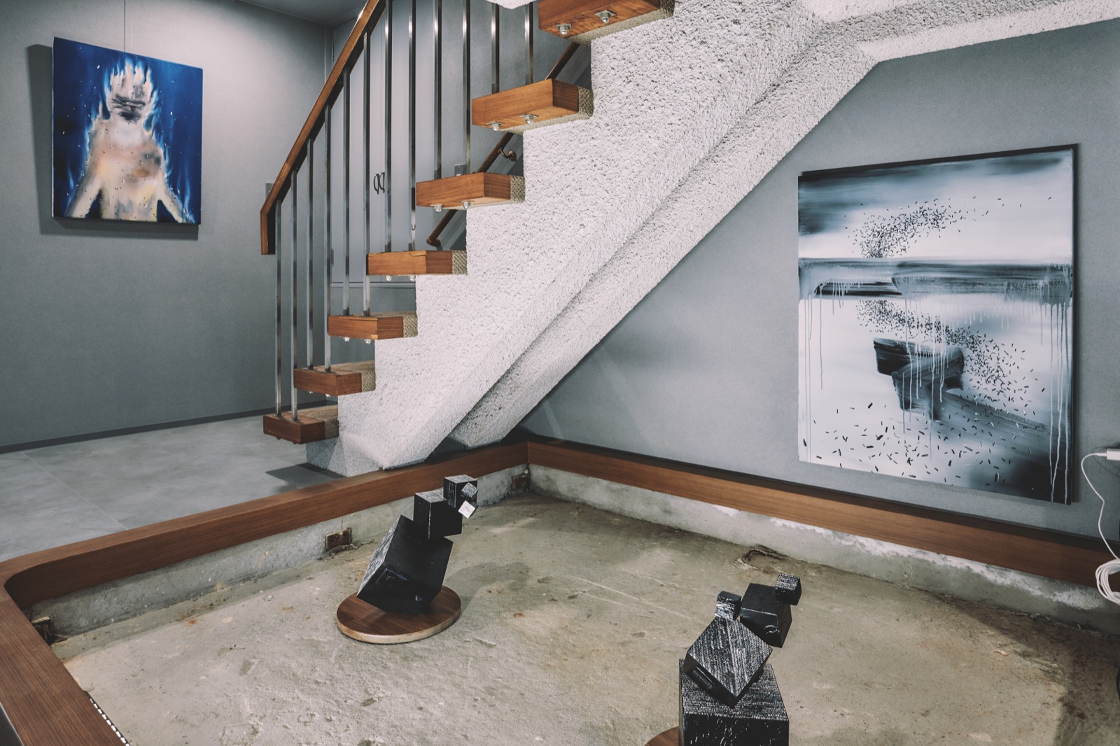 階段下ギャラリー空間 — アート作品と彫刻の展示